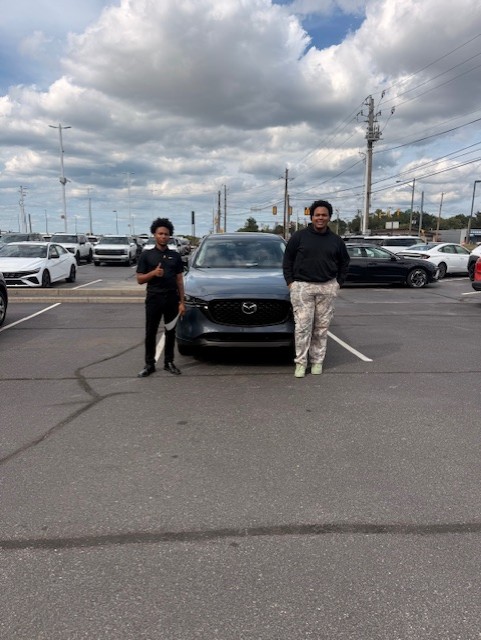 Damarion with a customer and their vehicle at Indy Hyundai